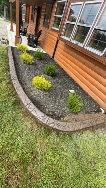 The garden bed with continuous decorative curbing after installation