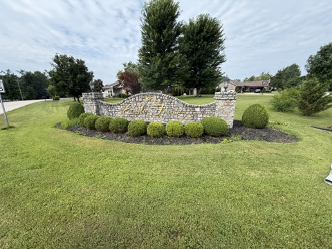 Neighborhood entrance garden before the new curbing
