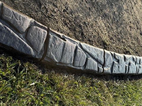 Close view of the stamped stone pattern in concrete curbing