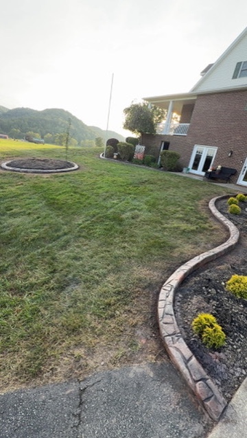 Overview of a lawn with completed curbing around garden beds